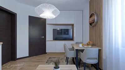 a dining room with a table and chairs and a television at Glečer Apartman 6 in Kopaonik
