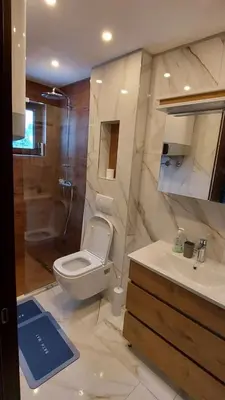 a bathroom with a toilet and a sink and a shower at Glečer Apartman 6 in Kopaonik