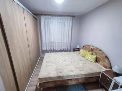 a small bedroom with a bed and a window at Apartman Kristina Ribarska banja in Kruševac