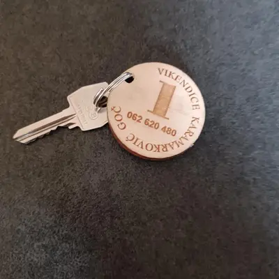 a silver keychain with a label on it at Vikendice Karamarković in Goč