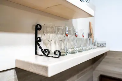 a row of wine glasses sitting on a shelf at Vikendice Karamarković in Goč