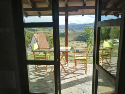 a view from the window of a house with a table and chairs at Vikendice Karamarković in Goč