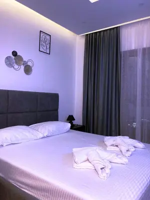 a bedroom with a bed with white towels on it at NLux46 Milmari in Kopaonik