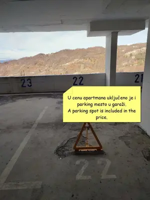 a sign sitting in the middle of a parking lot at NLux46 Milmari in Kopaonik
