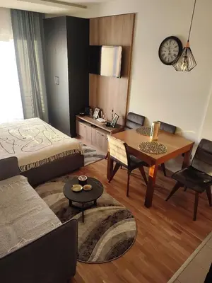 a living room with a bed and a table at NLux46 Milmari in Kopaonik
