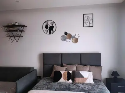 a bedroom with a gray bed with pillows on it at NLux46 Milmari in Kopaonik