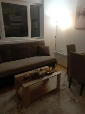 a living room with a couch and a coffee table at Apartman Bajka in Vrnjačka Banja