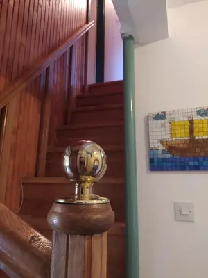 a gold object on a wooden post next to a staircase at Panorama in Vrnjačka Banja