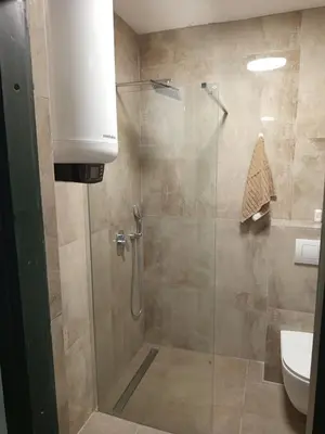 a bathroom with a shower with a glass door at Panorama in Vrnjačka Banja