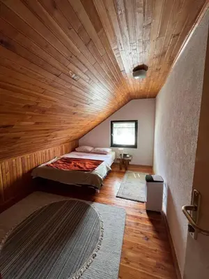 a room with two beds and a wooden ceiling at Panorama in Vrnjačka Banja