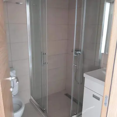 a bathroom with a shower and a toilet at PETRA Apartman Kopaonik in Kopaonik