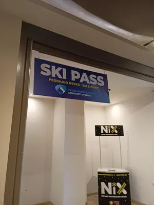 a sign for a ski pass sign on a wall at PETRA Apartman Kopaonik in Kopaonik