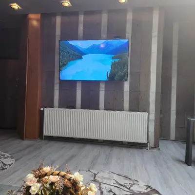 a flat screen tv on a wall in a room at IN CLUB in Vrnjačka Banja