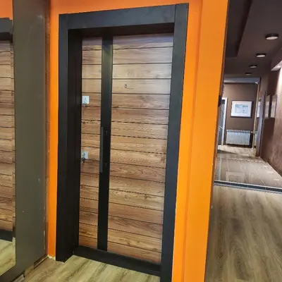 a sliding door in a hallway with wood panels at IN CLUB in Vrnjačka Banja