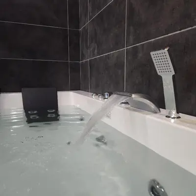 a bath tub filled with water with a laptop in it at IN CLUB in Vrnjačka Banja