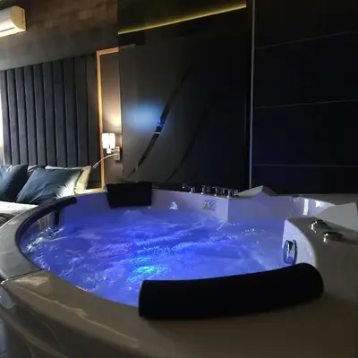 a large blue bath tub in a hotel room at IN CLUB in Vrnjačka Banja