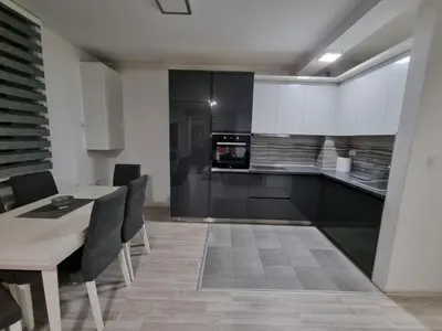 a kitchen with a dining table and a stove at Silver city 1 in Jagodina