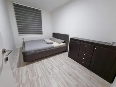 a small bedroom with a bed and a dresser at Silver city 1 in Jagodina