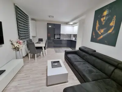 a living room with a couch and a table at Silver city 1 in Jagodina