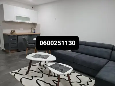 a living room with a couch and a table at Silver city 1 in Jagodina