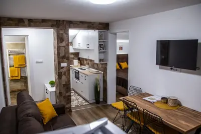 a living room with a couch and a table at Smile in Pirot