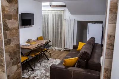 a living room with a couch and a table at Smile in Pirot