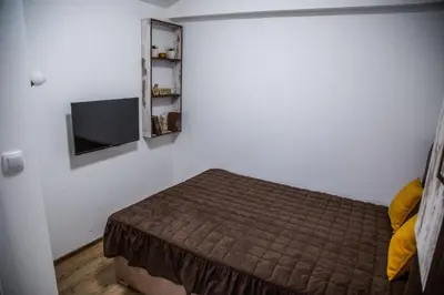 a bedroom with a bed and a flat screen tv at Smile in Pirot