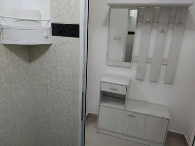 a bathroom with a shower and a sink and a mirror at Apartman Aleksić u samom centru grada in Knjazevac.