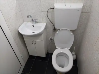 a small bathroom with a toilet and a sink at Apartman Aleksić u samom centru grada in Knjazevac.