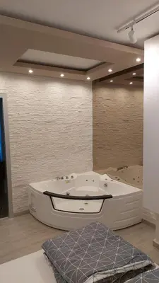 a large bathroom with a tub and two sinks at Apartman Nataly in Niš