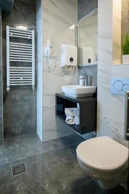 a bathroom with a toilet and a sink at Apartman Nataly in Niš