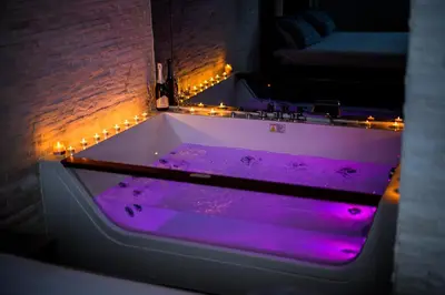 a purple tub in a room with lights at Spa Apartman Grand in Niš