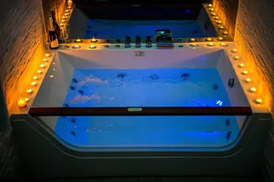 a large tub with lights in a room at Spa Apartman Grand in Niš