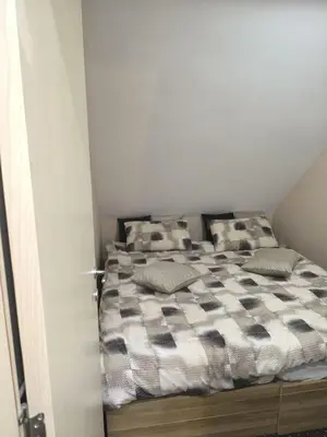 a bed in a room with two pillows on it at Konaci Kopaonik Lux Apartmani in Kopaonik