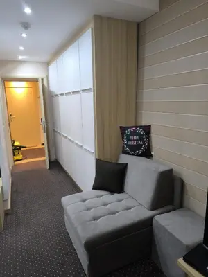 a living room with a couch in a room at Konaci Kopaonik Lux Apartmani in Kopaonik