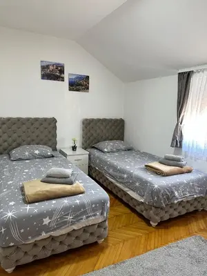 a bedroom with two beds and a window at Hostel Gray in Kruševac