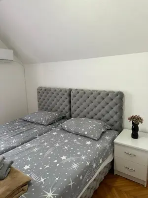 a bed with two pillows on it in a bedroom at Hostel Gray in Kruševac