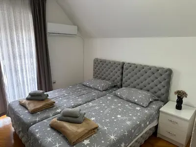 a bed with two pillows on it in a room at Hostel Gray in Kruševac