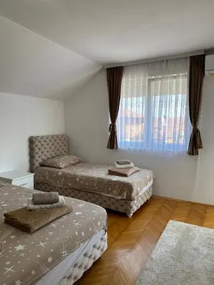 a bedroom with two beds and a window at Hostel Gray in Kruševac