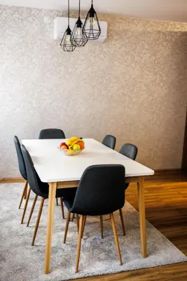 a table with chairs and a bowl of bananas on it at A Comfortable Base for Work & Life in Niš