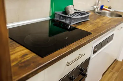 a kitchen counter with a sink and a dishwasher at A Comfortable Base for Work & Life in Niš