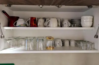 a cupboard filled with dishes and cups and plates at A Comfortable Base for Work & Life in Niš