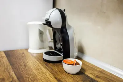 a coffee maker sitting on a wooden counter with a cup at A Comfortable Base for Work & Life in Niš