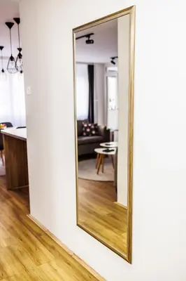 a large mirror on a wall in a living room at A Comfortable Base for Work & Life in Niš