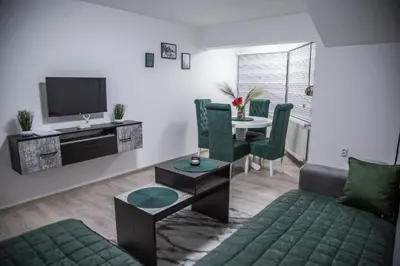a living room with a couch and a table at Happy in Pirot