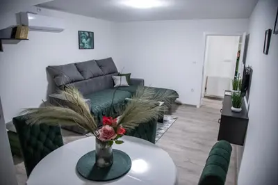 a living room with a couch and a table at Happy in Pirot
