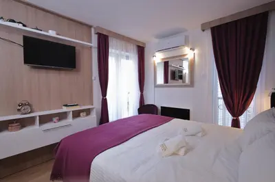 a hotel room with a large bed and a tv at GOLD Lux in Vrnjačka Banja
