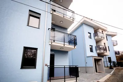 a building with balconies on the side of it at Apartman Hris in Vrnjačka Banja