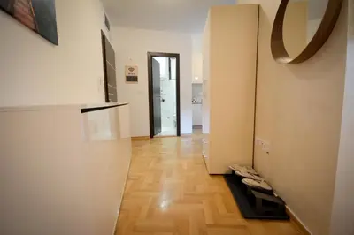 a hallway with white walls and a wooden floor at Apartman Hris in Vrnjačka Banja