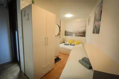 a small room with two beds and a closet at Apartman Hris in Vrnjačka Banja